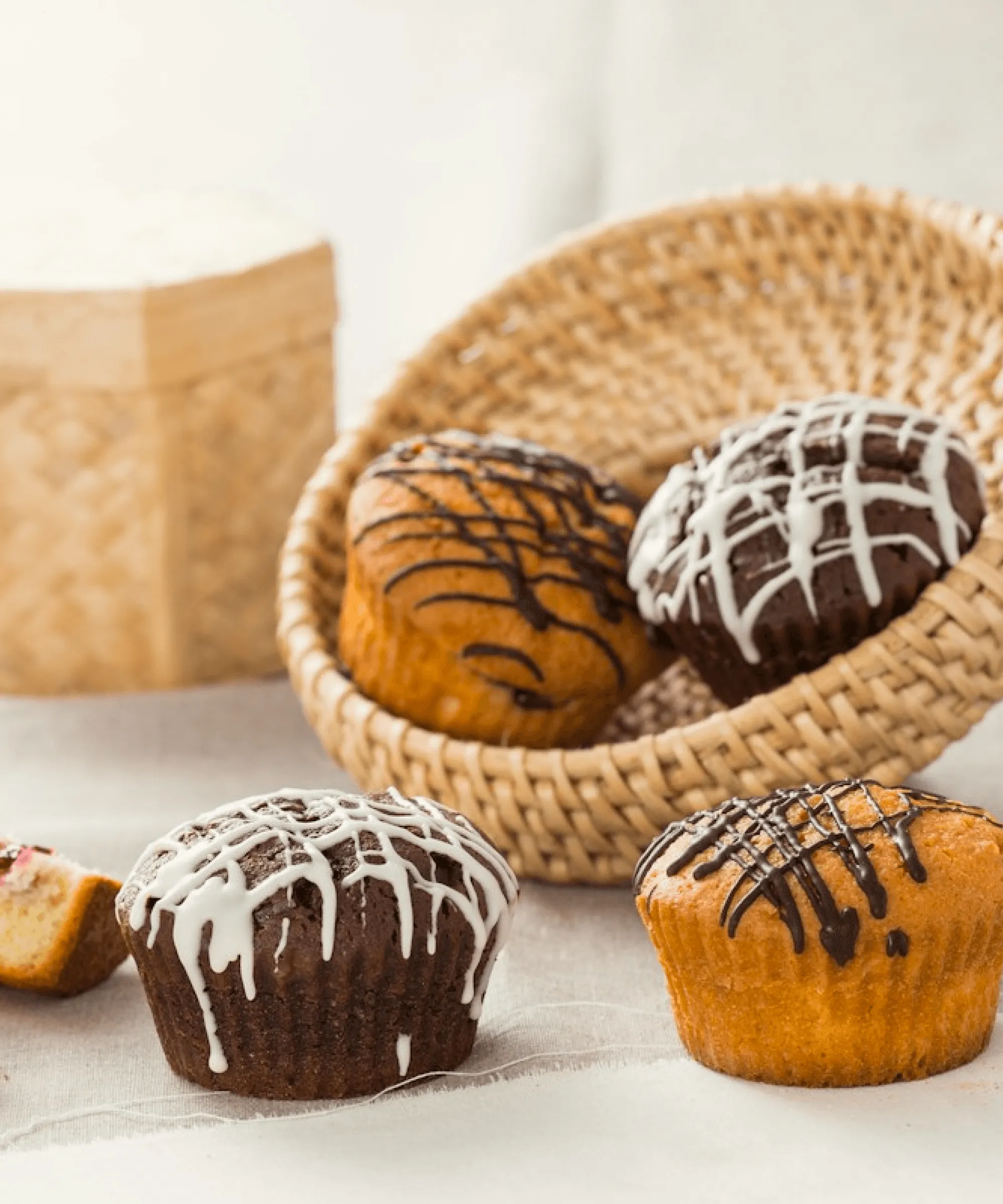 Chocolate-drizzled muffins in a woven basket